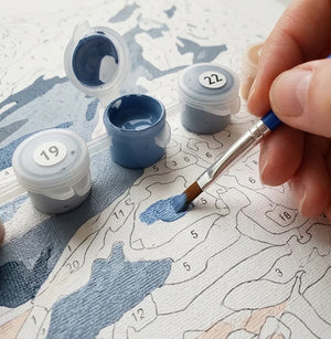 Painting numbered canvas with brush